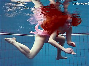 sandy-haired Simonna flashing her assets underwater
